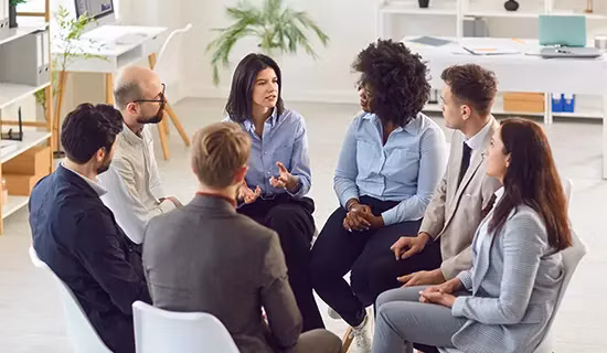 A group of people talking in a circle